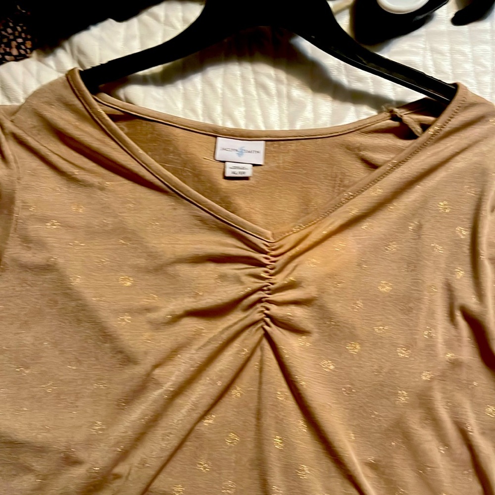 A crimped look blouse. Never used! Great for evening or day.